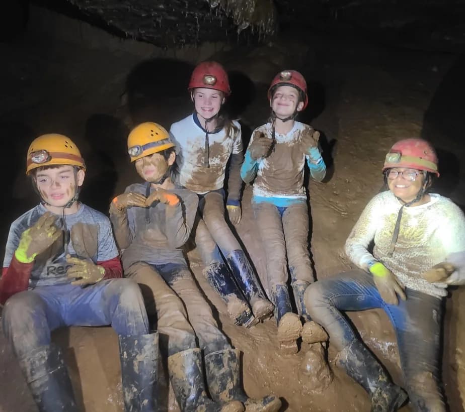Grade 6 students in caving helmets inside Mammoth Cave